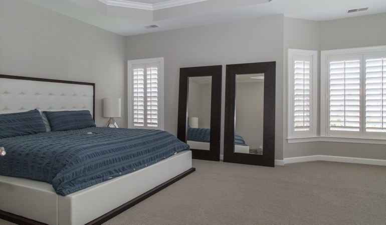 White shutters in a minimalist bedroom in San Antonio.